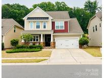 Charming two-story home with manicured lawn, neutral siding, and a two-car garage at 3005 Oakmere Rd, Waxhaw, NC 28173