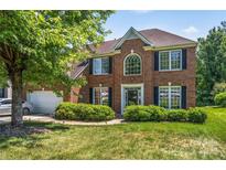 Lovely brick home featuring lush green landscaping, manicured lawn and a two-car garage at 3124 Arklow Rd, Charlotte, NC 28269