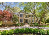 Charming two-story home featuring a manicured lawn, fountains, and lush landscaping in a desirable neighborhood at 6914 Riesman Ln # 95, Charlotte, NC 28210