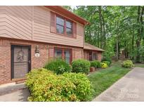 Charming townhome featuring brick and siding, complemented by mature landscaping and window shutters at 119 Mary Louise Ct, Fort Mill, SC 29715