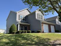Inviting two-story home with manicured lawn and a two-car garage, perfect for suburban living at 12120 Stratfield Place Cir, Pineville, NC 28134