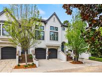 Charming townhome featuring a manicured front yard, a private garage, and a beautifully painted exterior at 208 Wendover Heights Cir, Charlotte, NC 28211