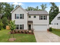 Charming two-story home with white siding, shutters, and a well-manicured lawn at 2535 Andes Dr, Statesville, NC 28625