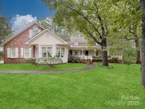 Charming home with manicured lawn, front porch, and a blend of brick and siding at 2721 Tara Dr, Monroe, NC 28112