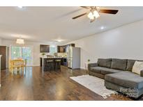 Open-concept living space featuring hardwood floors, modern furnishings, and a seamless flow to the kitchen at 2835 24Th Street Ne Dr, Hickory, NC 28601