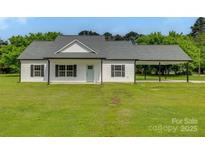 Charming single-story home with white siding, a well-manicured lawn, and a convenient attached carport at 5705 White St, Fort Lawn, SC 29714