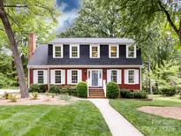 Charming two-story home featuring a well-manicured lawn and mature trees at 6007 Patrick Pl, Charlotte, NC 28210