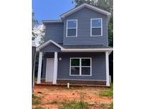Two-story home features gray siding, white trim, covered porch and a well-lit, eye-catching, exterior elevation at 115 Allen St, Rock Hill, SC 29730