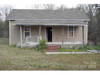 Quaint single-story home featuring a covered porch, light siding, and a well-maintained roof at 120 Mccleave Rd, China Grove, NC 28023