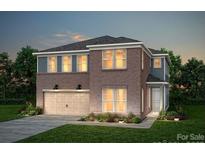 Charming two-story home with brick facade, double garage, and inviting curb appeal at 1529 Gossage Nw Ln, Concord, NC 28027