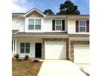 Charming townhome with white siding, stone accents, and single-car garages at 175 Limerick Rd # C, Mooresville, NC 28115