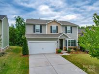 Charming two-story home features a gray exterior, a two-car garage, and a well-manicured front yard at 2037 Christopher Wood Ct, Indian Land, SC 29707