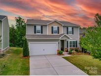 Charming two-story home featuring a two-car garage, well-manicured lawn, and inviting curb appeal at 2037 Christopher Wood Ct, Indian Land, SC 29707