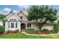 Charming home featuring a stone facade, well-maintained landscaping, and inviting curb appeal at 21300 Crown Lake Dr, Cornelius, NC 28031