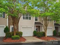 Charming townhome featuring a stone facade, lush landscaping, and a convenient one-car garage at 2137 Midnight Blue Ln, Fort Mill, SC 29708