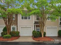 Inviting townhome exterior with attached garage, decorative stone accents, and mature trees at 2137 Midnight Blue Ln, Fort Mill, SC 29708