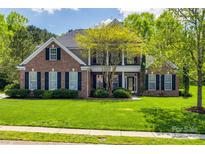 Traditional two-story brick home with manicured lawn and black shutters at 2235 Legacy Oak Dr, Waxhaw, NC 28173
