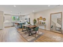 Bright dining area featuring a wood table, modern decor, open to the gourmet kitchen and a great view at 355 S Bruns Ave, Charlotte, NC 28208