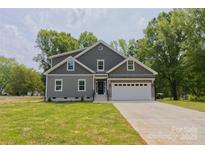 Charming two-story home with a well-manicured lawn and attached two-car garage at 4006 Scarlet Dr # 29, Matthews, NC 28104