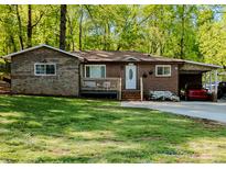 Charming brick home with stone accents, a carport, and a well-maintained front yard at 403 3Rd Nw St, Conover, NC 28613