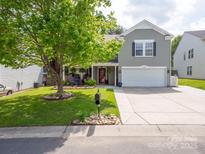 Charming two-story home boasts lush landscaping and a well-manicured lawn at 4148 Shasta Cir, Clover, SC 29710