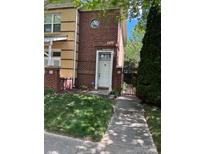Charming brick townhome featuring a well-maintained lawn and inviting entryway at 510 N Alexander St, Charlotte, NC 28202