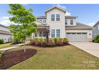 Charming two-story home with a manicured front yard and a two-car garage at 528 Rock Skip Way, Fort Mill, SC 29708
