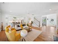 Open-concept living room flows to kitchen, showcasing hardwood floors and a cozy, inviting atmosphere at 528 Rock Skip Way, Fort Mill, SC 29708