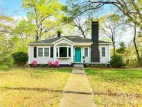 Charming single-story home featuring a bright blue front door, bay window, and a well-manicured lawn at 645 Wilshire Sw Ave, Concord, NC 28027
