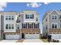 Beautiful townhome with stone accents, a two-car garage, and a modern design at 9823 Oaklawn Nw Blvd, Huntersville, NC 28078