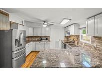 Bright kitchen features white cabinets, stainless steel appliances, granite countertops, and modern fixtures at 1005 Caldon Dr, Stanley, NC 28164