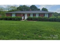 Charming brick home with a lush green lawn and manicured bushes, offering great curb appeal at 1165 Mt Moriah Church Rd, China Grove, NC 28023