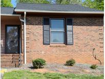 Brick townhouse exterior with dark shutters, a brown roof, and a dark-trimmed front door at 149 Glenwood Dr, Rock Hill, SC 29732