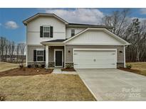Charming two-story home featuring a two-car garage and covered front porch at 2127 Rolling Hills Ct, Stanley, NC 28164