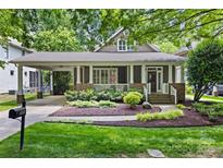 Charming home exterior featuring a covered porch, well-manicured landscaping, and a welcoming entrance at 2311 Club Rd, Charlotte, NC 28205