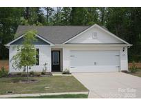 Charming single-story home featuring a two-car garage, black door, and well-manicured front lawn at 3138 Maple Ridge Dr, Gaston, NC 28052