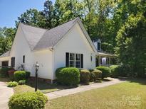 Charming home featuring a landscaped front yard, complemented by lush greenery and classic architectural details at 406 Brentwood Cir, Kannapolis, NC 28081