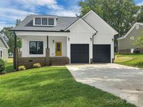 Charming home with a bright yellow door, black garage doors, and a well-manicured lawn at 420 Fulton Dr, Kings Mountain, NC 28086