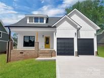 Charming two-story home with a yellow door and a two-car garage at 420 Fulton Dr, Kings Mountain, NC 28086