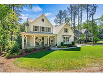 Charming home featuring a well-maintained lawn, inviting front porch, and tasteful landscaping at 4290 Palm Dr, Denver, NC 28037