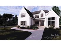 Stunning two-story modern farmhouse exterior with light gray pathway and lush landscaping at 4609 Firethorn Ct, Denver, NC 28037
