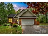 Charming brick home with landscaped front yard and attached two-car garage, perfect for suburban living at 4927 Gateway Dr, Claremont, NC 28610
