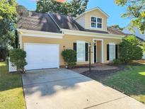 Charming single-Gathering home featuring a two-car garage and manicured front yard under a clear blue sky at 6007 Kenmore Ln, Indian Trail, NC 28079
