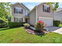 Charming two-story home with red shutters, a well-manicured lawn, and a beautiful flower bed at 1218 Faversham Ln, Rock Hill, SC 29730