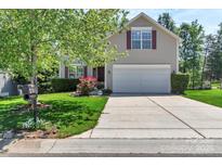 Charming two-story home with attached two-car garage and well-manicured front lawn and mature landscaping at 1218 Faversham Ln, Rock Hill, SC 29730