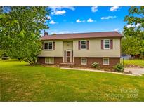 Charming home with a well-maintained lawn, beautiful landscaping, and inviting facade at 1260 Summer Ln, Salisbury, NC 28146