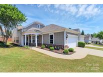 Charming single-Gathering home with manicured lawn, two-car garage, and covered front porch in desirable neighborhood at 18020 Owl Ct, Indian Land, SC 29707