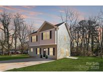 Charming two-story home with neutral siding, manicured lawn and inviting curb appeal at 2123 Gemway Dr, Charlotte, NC 28216