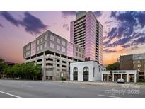 Street view of building featuring modern architecture and nearby shops against a beautiful sky at 315 Arlington Ave # 1104, Charlotte, NC 28203