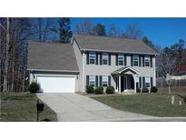 Traditional two-story home featuring a gray exterior, well-maintained landscaping, and an attached two-car garage at 400 Antlers Ct, Gastonia, NC 28052